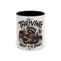 Thriving Raccoon Accent Coffee Mug — "Thriving Wasn't in the Budget" Funny Gift